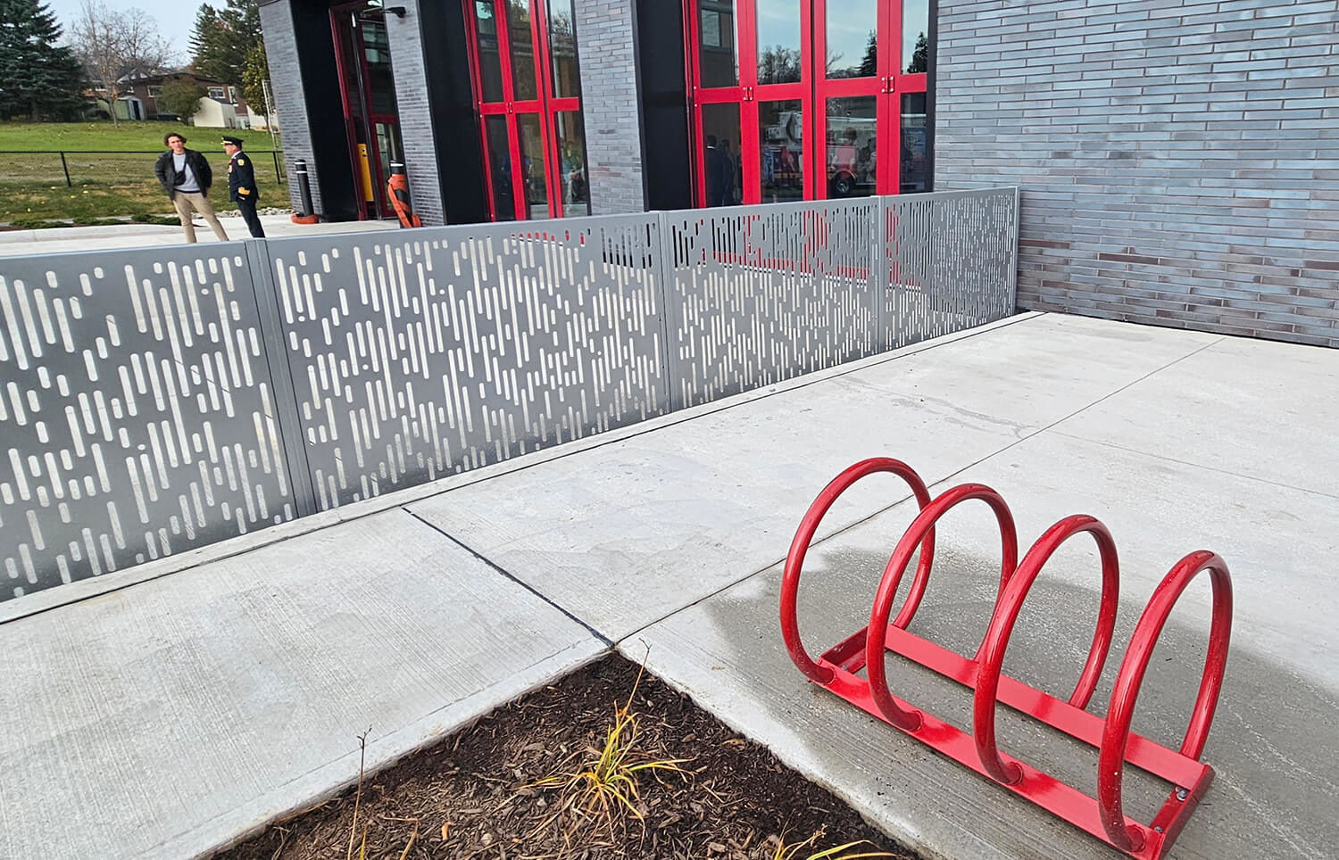 FLEXX panels outside a fire station with bike rack in foreground