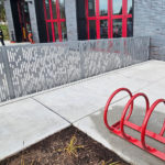 FLEXX panels outside a fire station with bike rack in foreground