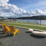 Cloudy bright blue skies with water and 720 Maglin yellow chairs
