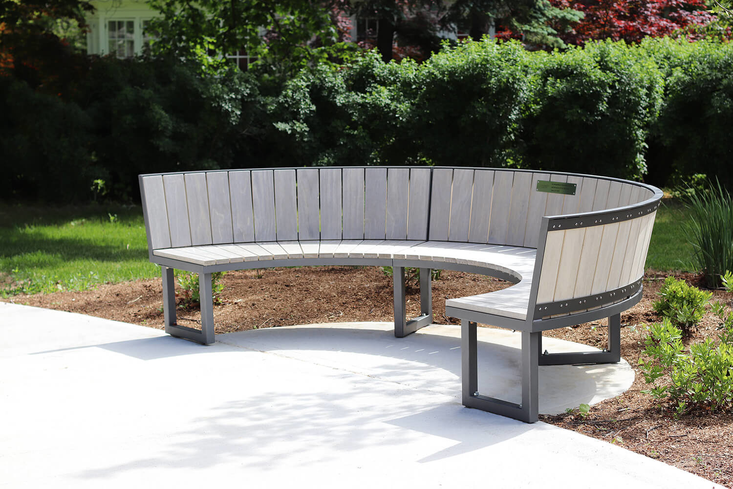 Curved Ogden bench with custom accoya wood at the University of Guelph's Lang Plaza