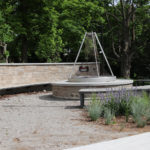 Curved Ogden benches surround fire pit at the University of Guelph - Lang Plaza
