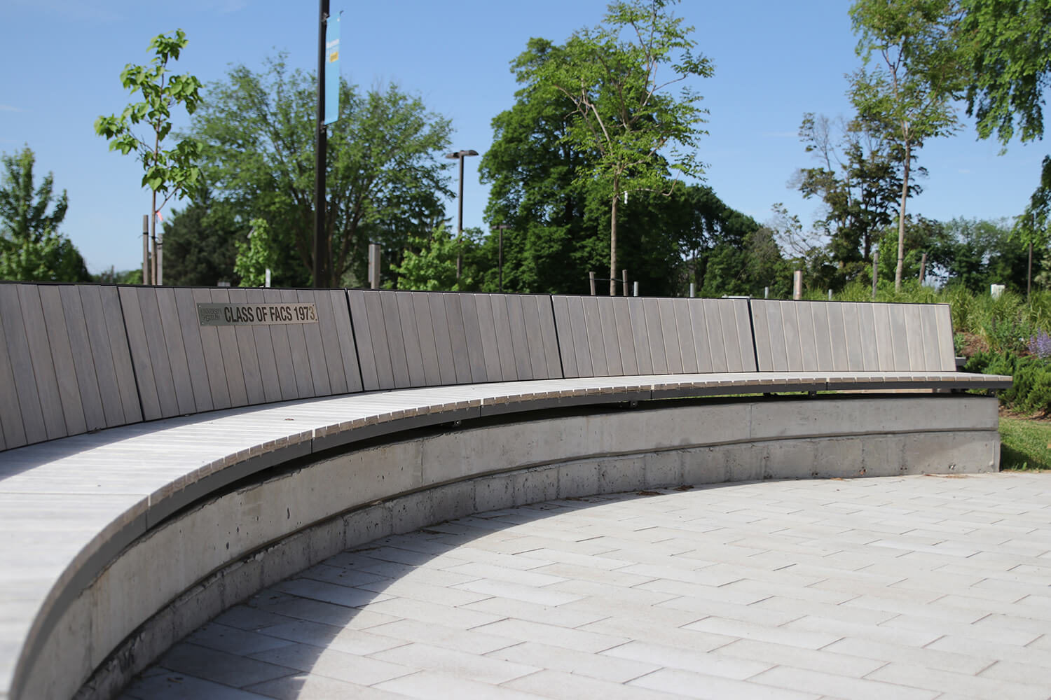 Curved Ogden wall mount bench at University of Guelph Lang Plaza