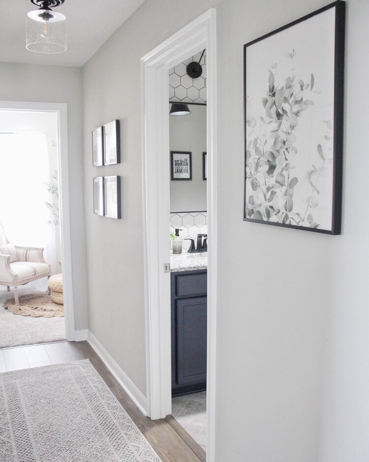 Doorway with no door opening into a modern white bathroom.