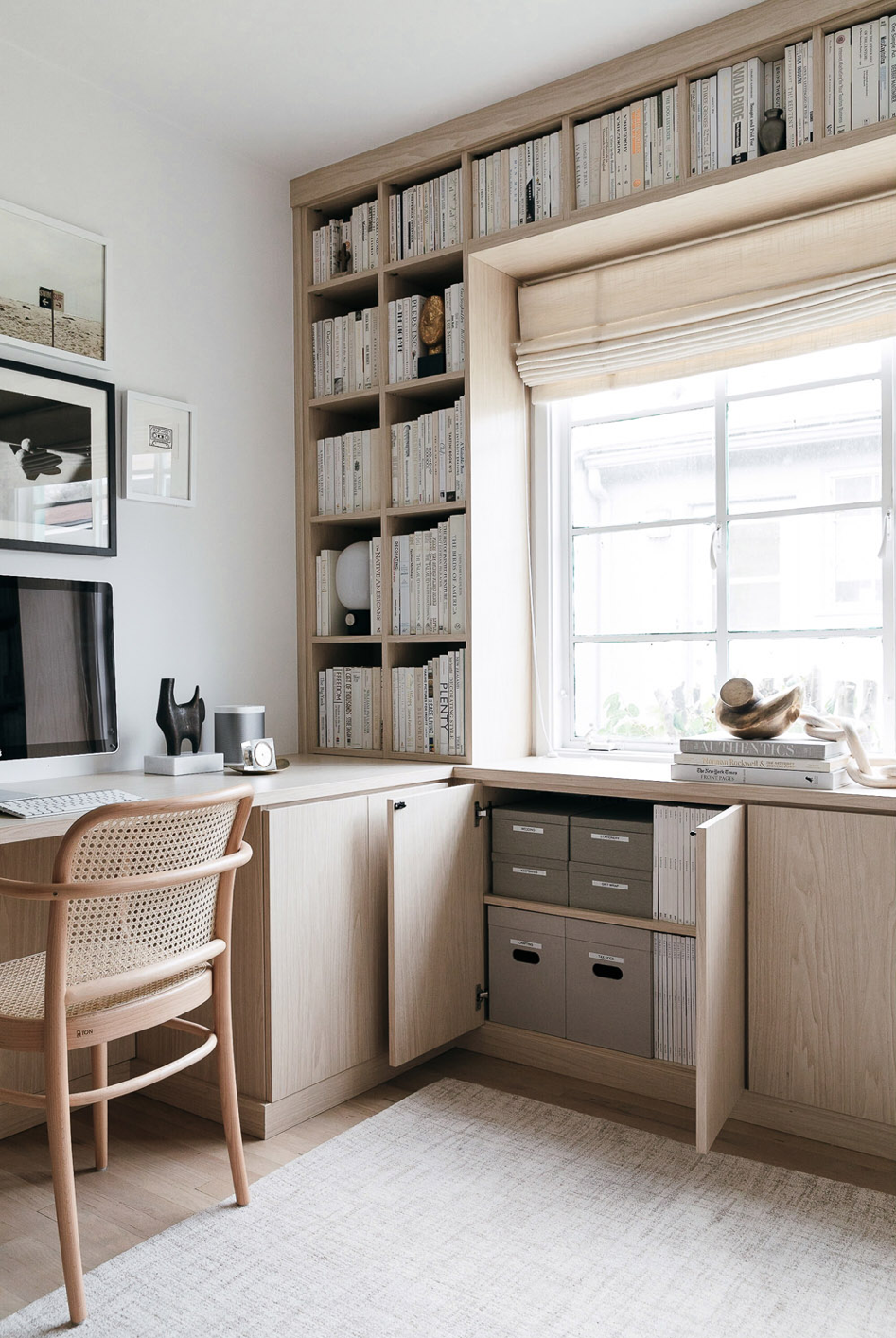 Light wood oak office with a window and lots of book shelves