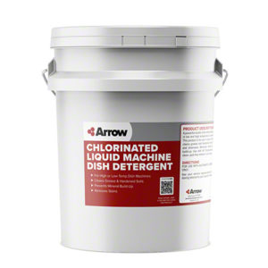 A large white plastic pail labeled "CHLORINATED LIQUID MACHINE DISH DETERGENT, 5gal/pail" with product details and usage instructions.