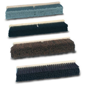 Four distinct broom heads featuring bristles in blue, black, brown, and dark gray tones are arranged in a vertically stacked manner. Featured amongst them is the 24" Gray/Green Flagged Bristles Push Broom with Wood Block designed for fine sweeping.