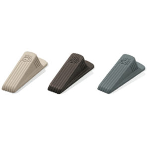 Three BIG FOOT DOOR STOPs in beige, brown, and gray placed in a row.