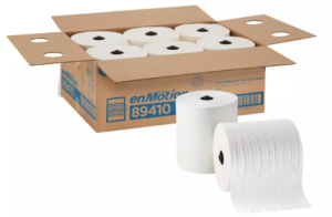 A cardboard box labeled "89410 ENMOTION 8" PREMIUM WHITE ROLL TOWELS" contains six large rolls of white paper towels, each roll measuring 425 feet. Two rolls are positioned in front of the box, one standing upright and the other slightly unraveled.