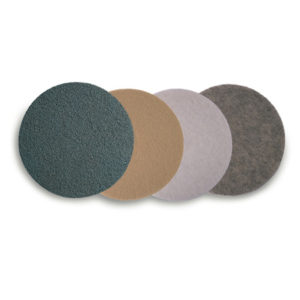 Displayed in a row are four 20" JACKAROO Lite Natural Hairburnishing Floor Pads, each with a distinct color: dark green, beige, light gray, and dark gray.