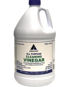 Plastic jug labeled "WHITE CLEANING VINEGAR 5% ALLPURPOSE, 4/GAL/CS," indicating ammonia-free, fights odors, and net contents of one gallon.