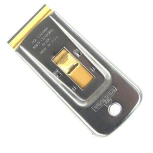 STAINLESS STEEL SAFETY SCRAPER with a gold-colored blade and a sliding mechanism for blade adjustment; the word "UNGER" is embossed on the handle. Uses #9 blades.