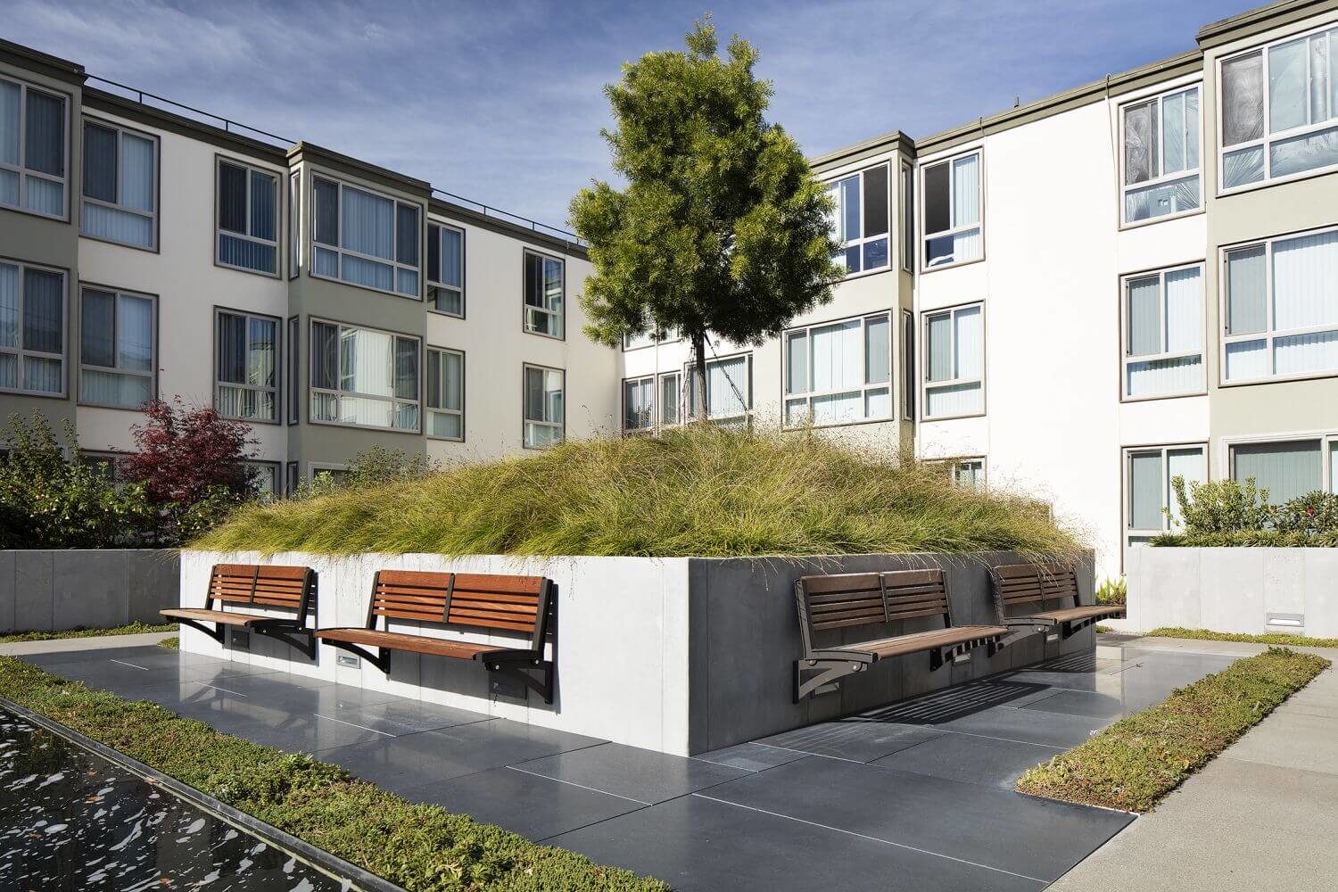 Backed Benches attached to Concrete Near Apartment Complex