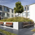 Backed Benches attached to Concrete Near Apartment Complex
