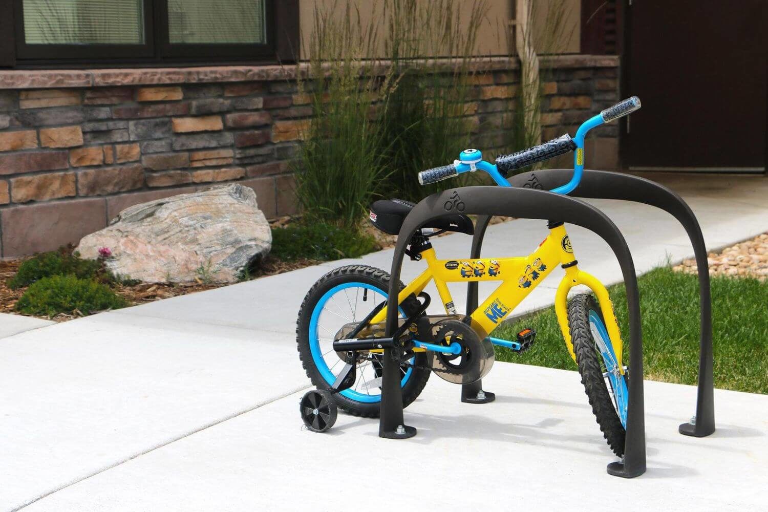 Yellow childrens bike on bike rack