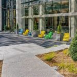 Yellow, Green and Blue patio seating outside glass building