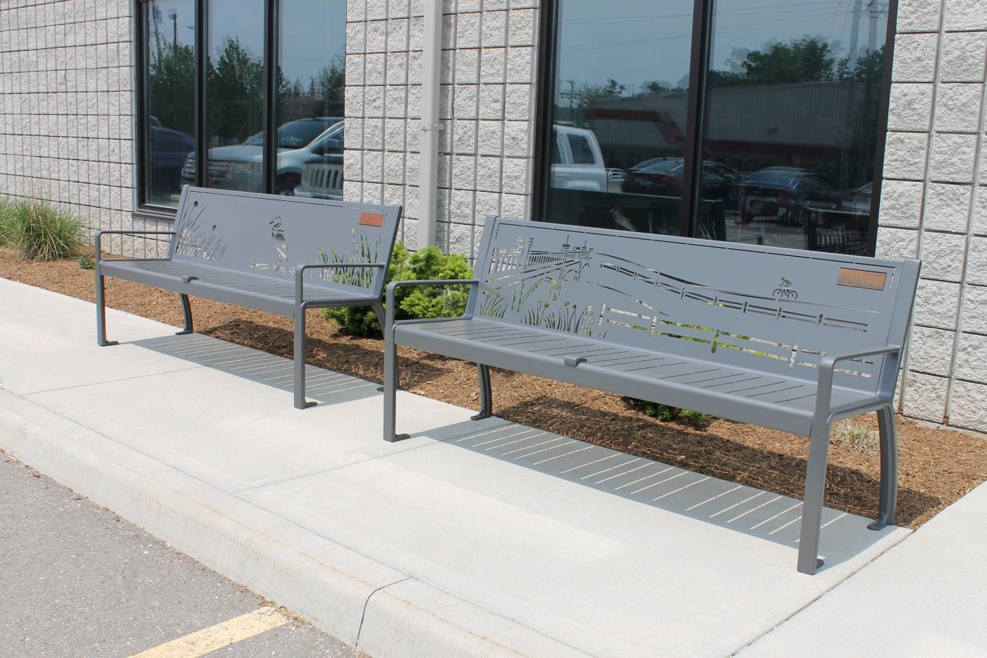 Two metal benches with designs carved in