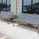 Two metal benches with designs carved in