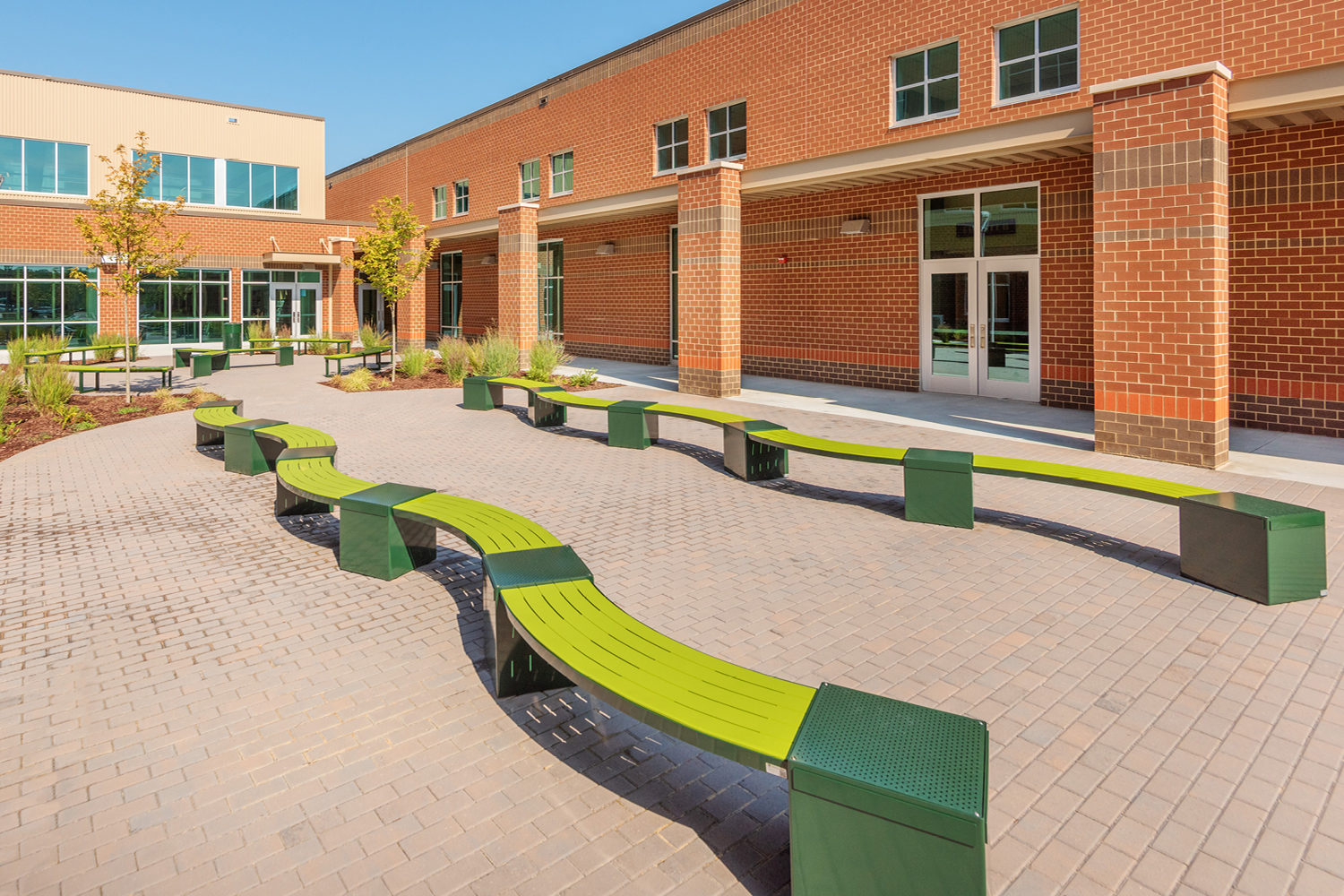 Green Lexicon seats with square modules in school yard