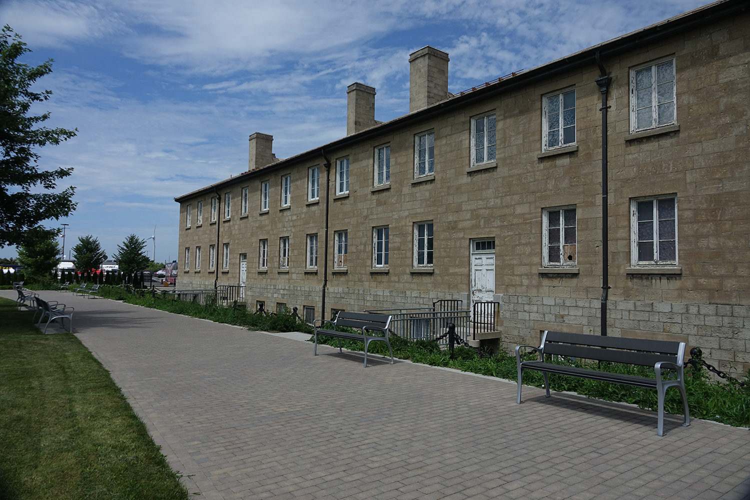 870 Backed Benches in front of brown building