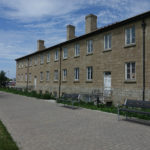 870 Backed Benches in front of brown building