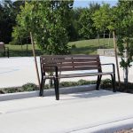 Iconic Backed Benches surrounded by trees in park setting