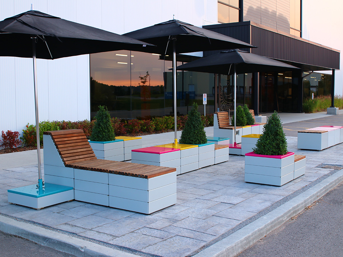 Pixel blocks with brightly painted tops and Tuuci umbrellas at Maglin Site Furniture