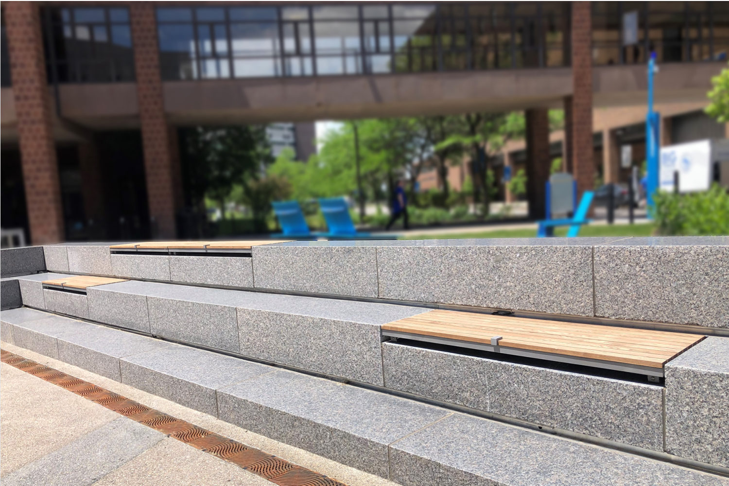 Wall-mount Ogden seats with Thermally Modified Ash Wood in university courtyard