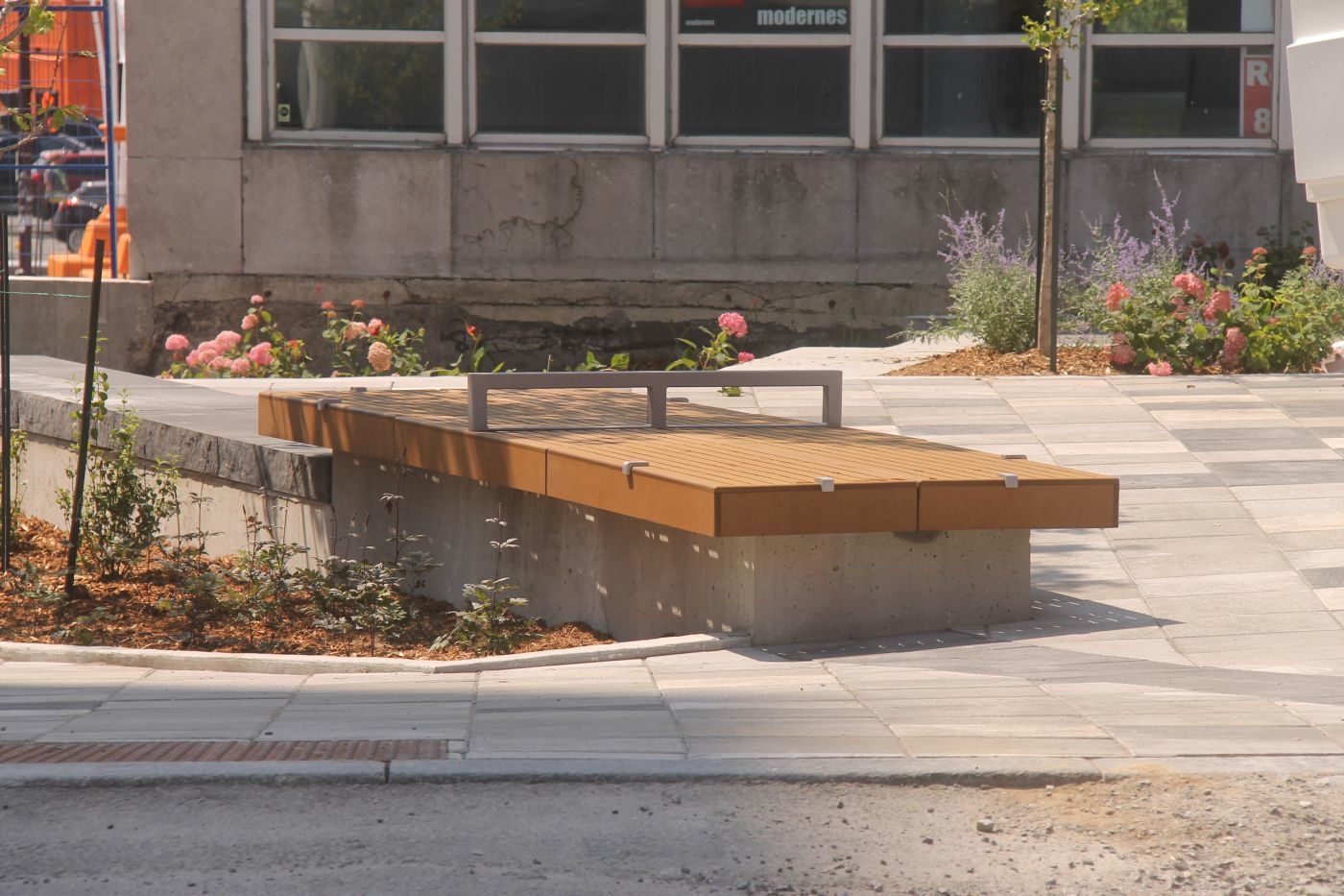 Two identical seating platforms near small flowerbed