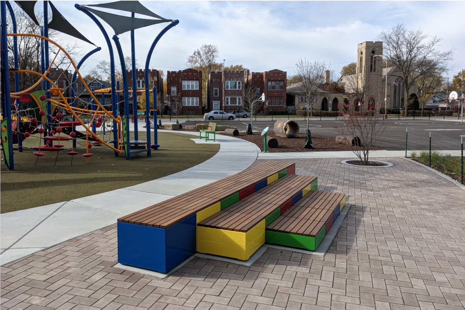 Brightly painted Pixel blocks stacked next to playground
