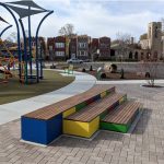 Brightly painted Pixel blocks stacked next to playground