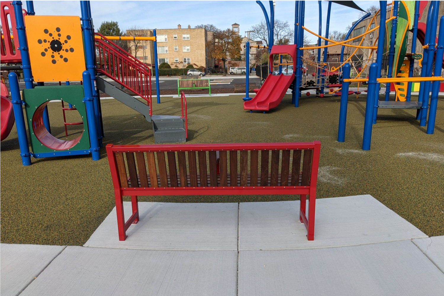 Brightly painted 400 series benches at school playground