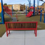 Brightly painted 400 series benches at school playground