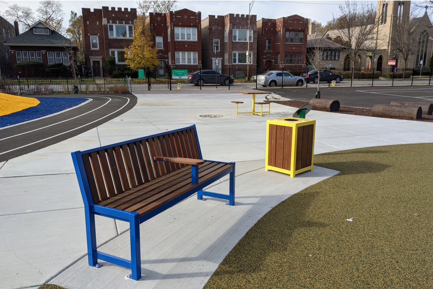 Blue Powdercoat 400 Series Bench with 1050 trash container at school