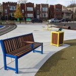 Blue Powdercoat 400 Series Bench with 1050 trash container at school
