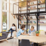 Resources library with students helping one another