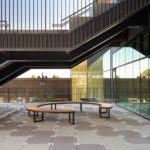 Circular Ogden Bench under staircase at Menlo Park High School