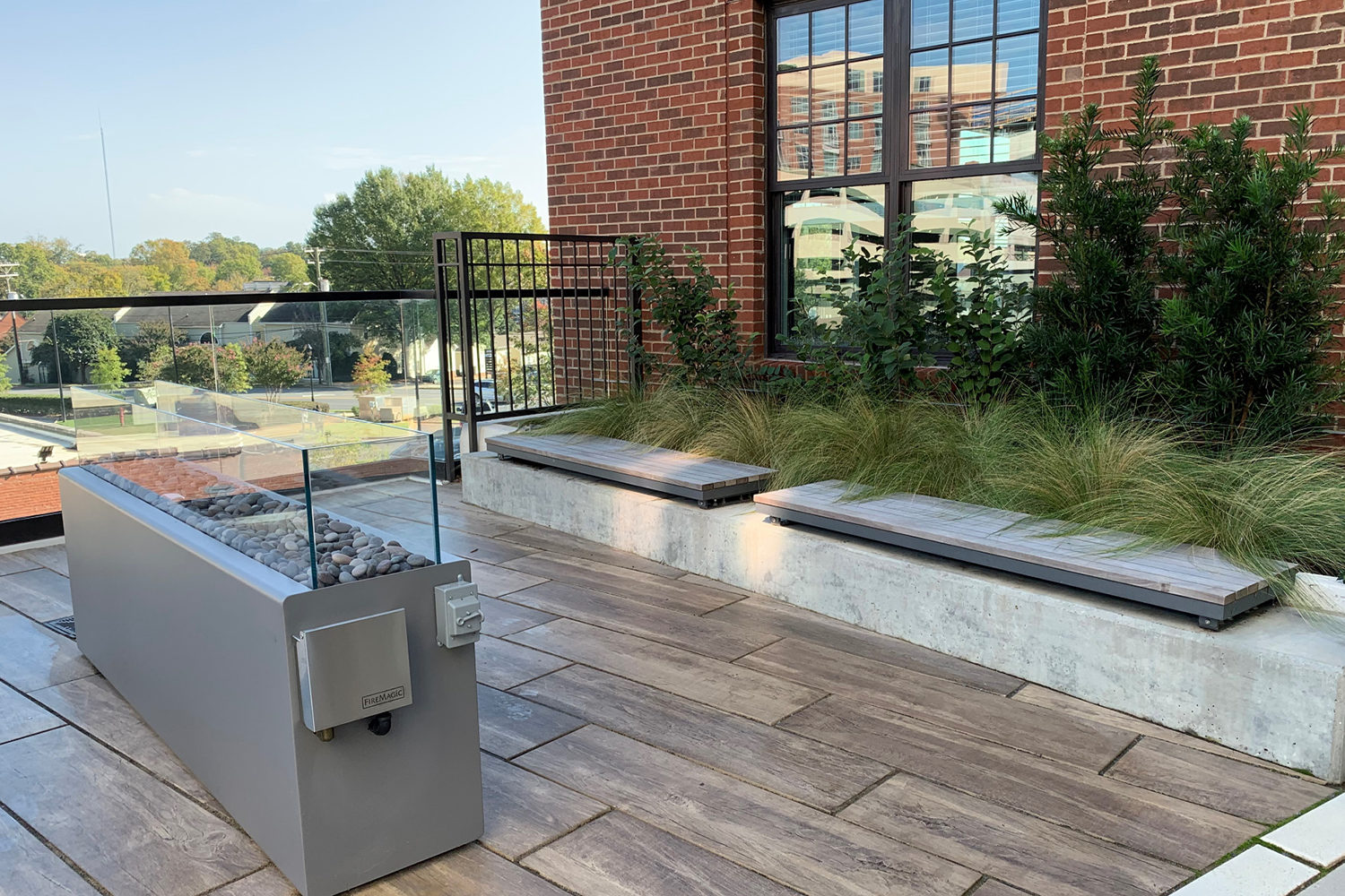 Rooftop patio featuring Ogden straight benches and a fire feature