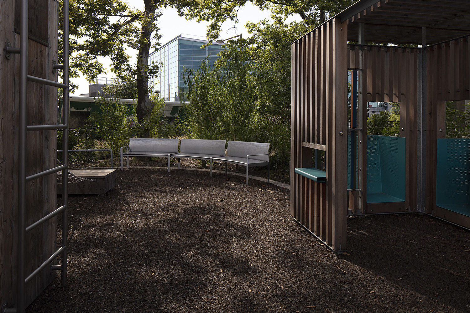 Battery-Playscape_custom-curved-bench_004 Curved custom Maglin benches behind a wooden play structure at the Battery Playscape