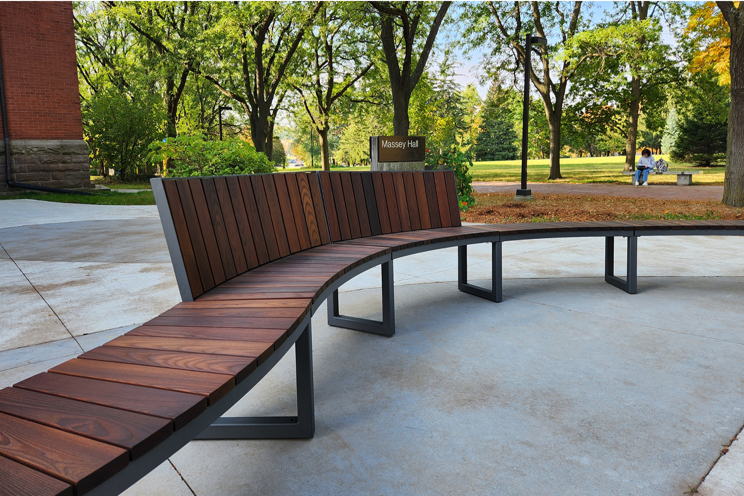 Curved Ogden backed and backless bench in public green space