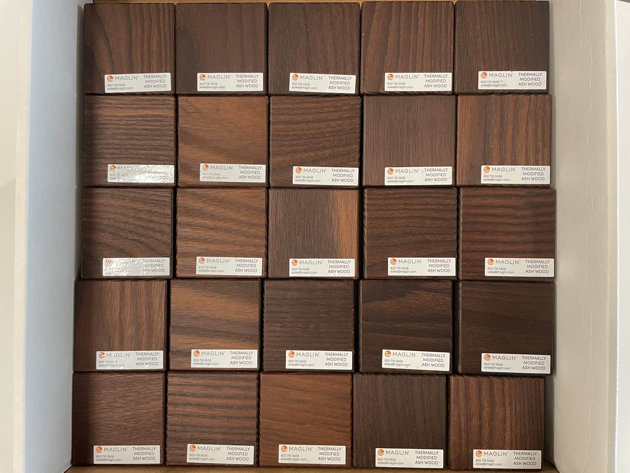 An open box with samples of Thermally Modified Ash Wood blocks at Maglin.