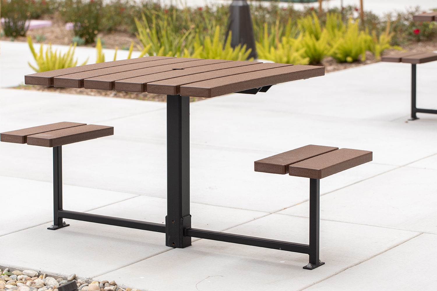 Maglin two-seat 400 Series cluster seating unit is installed on concrete in an apartment amenity courtyard in Chula Vista, CA.
