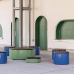 Pixel Rounds painted Reseda Green and Violet next to building with arched windows and doors