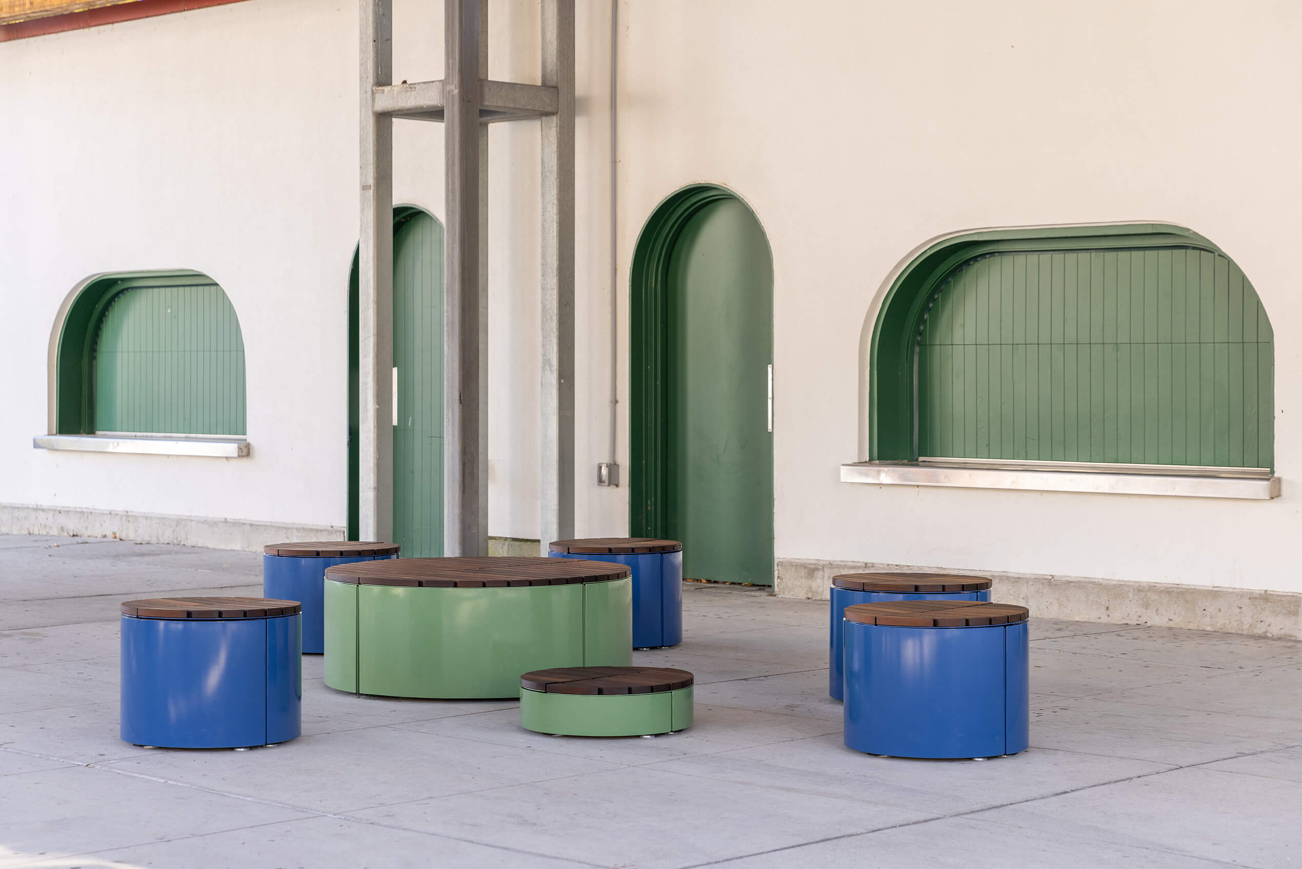 Pixel Rounds painted Reseda Green and Violet next to building with arched windows and doors