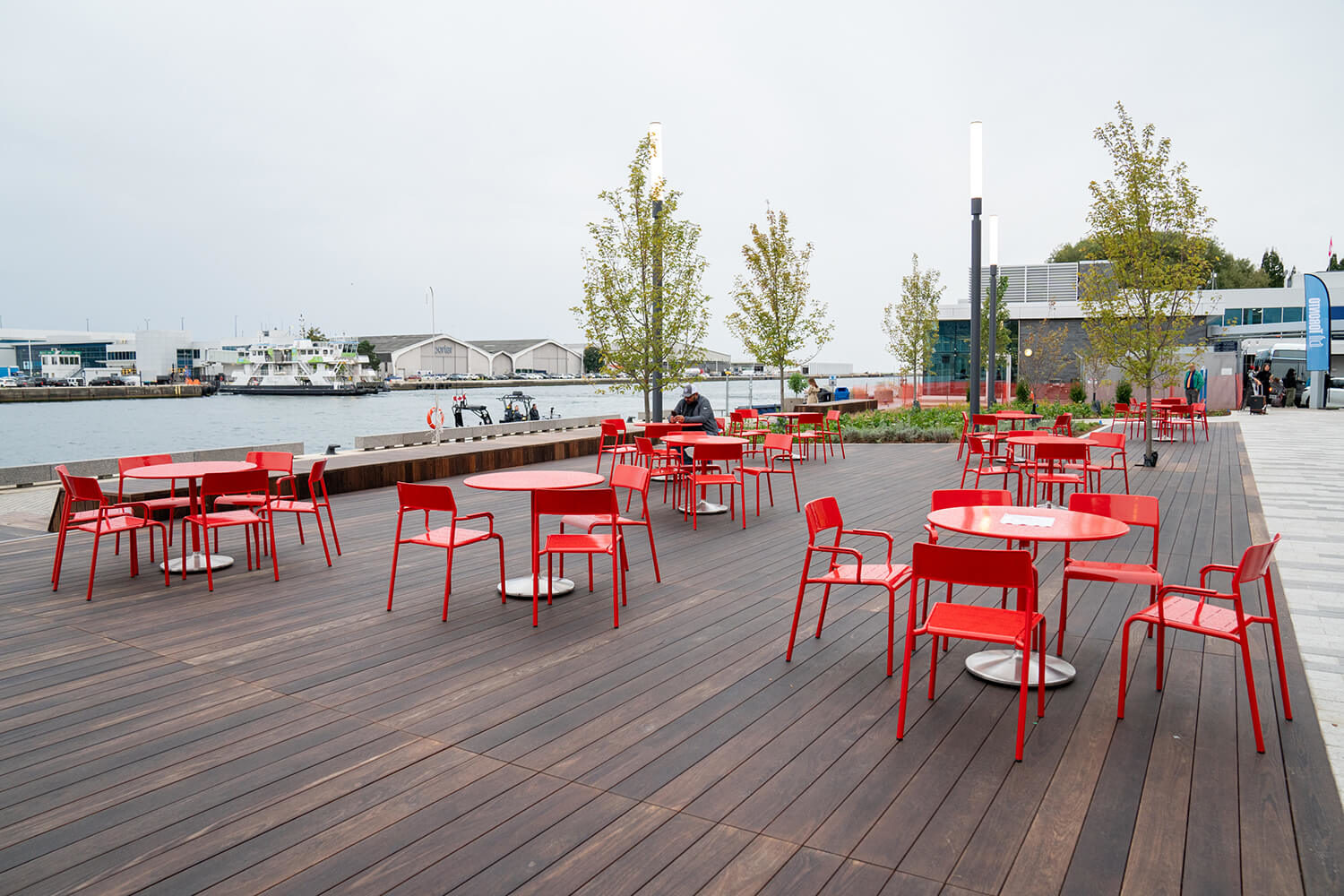 Several Maglin Foro tables and chairs overlooking the water at Bathurst Quay Common in Toronto Ontario