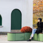Maglin Pixel collection rounded tall blocks with women sitting, white and green building in background