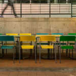 Brightly painted Foro chairs and tables at UNC outdoor corridor