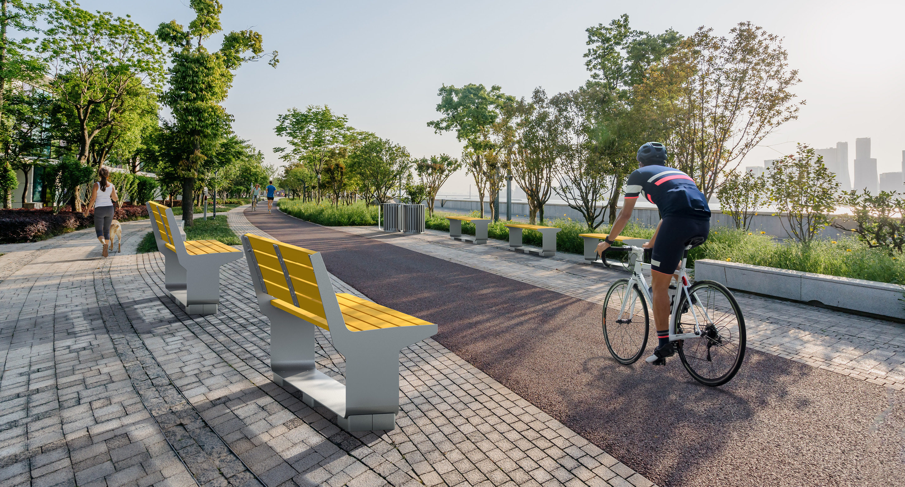 maglin-collections_l-series-car3 Cyclist riding past two yellow benches and women walking dog in the distance