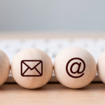 Contact icons - phone, email, @ and mobile on wooden balls