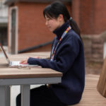 Student sitting at Ogden modular table with laptop