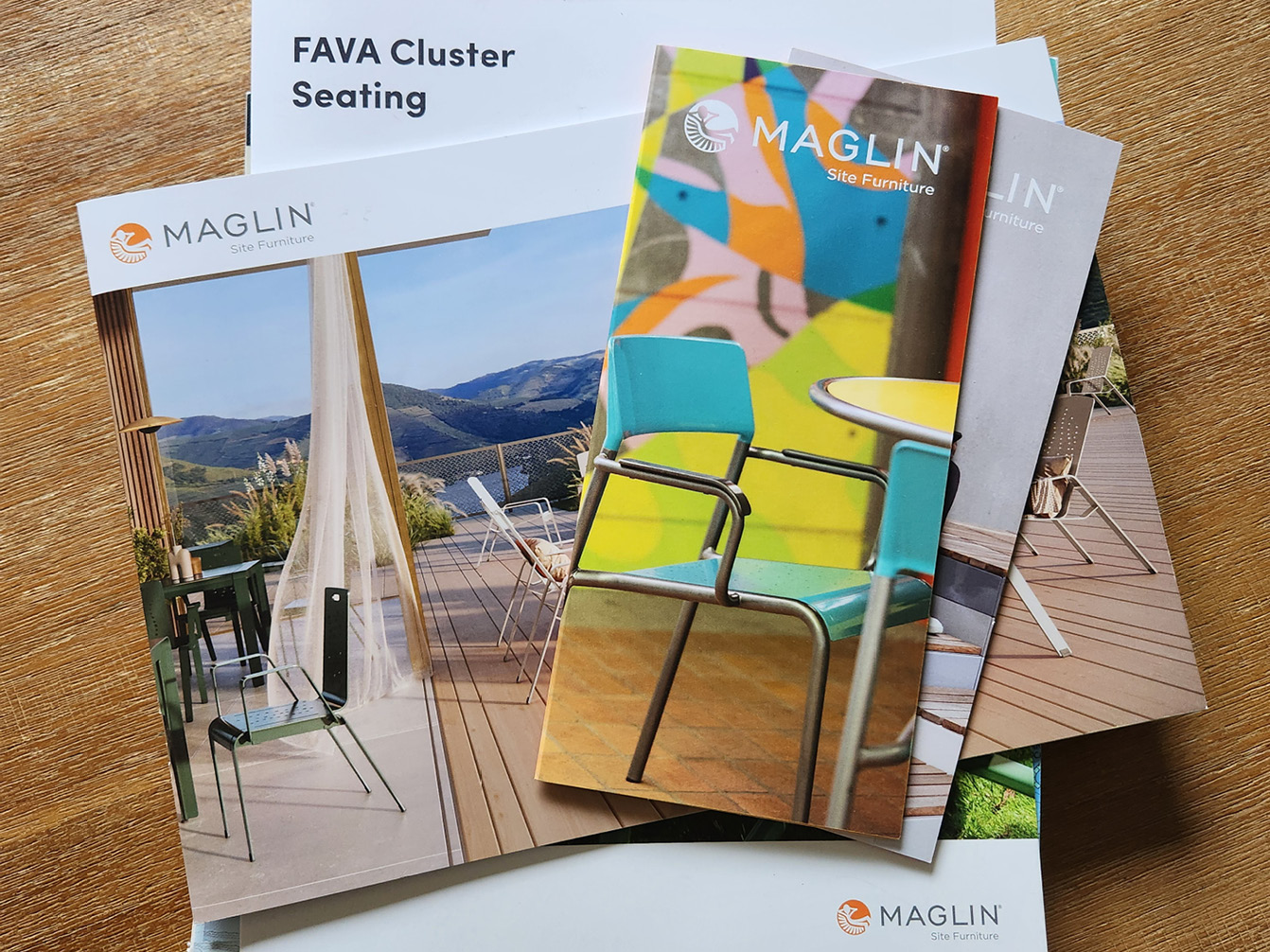 Pile of Maglin brochures on wooden table
